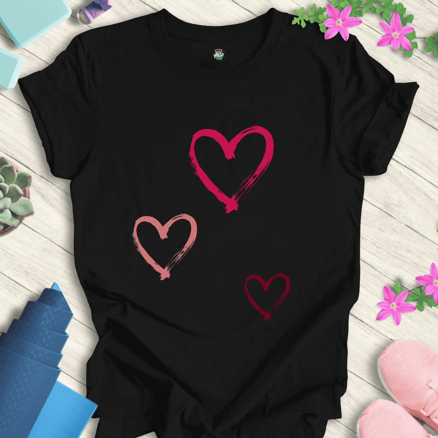 Black yoga t-shirt with 'Halo Allo Love All Around' design, featuring three heart motifs, perfect for spiritual wellness.