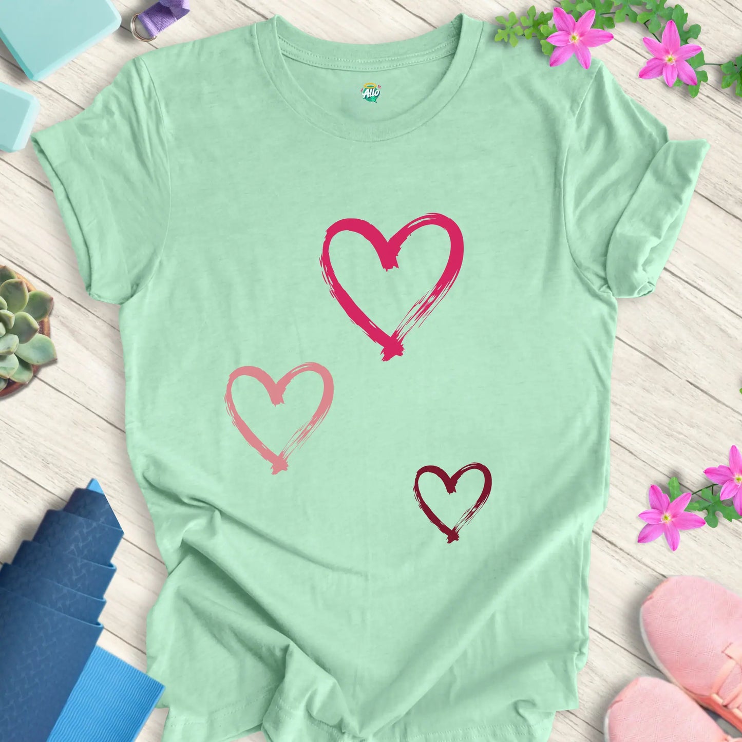 Heather Mint yoga t-shirt with 'Halo Allo Love All Around' design, featuring three heart motifs, perfect for spiritual wellness.