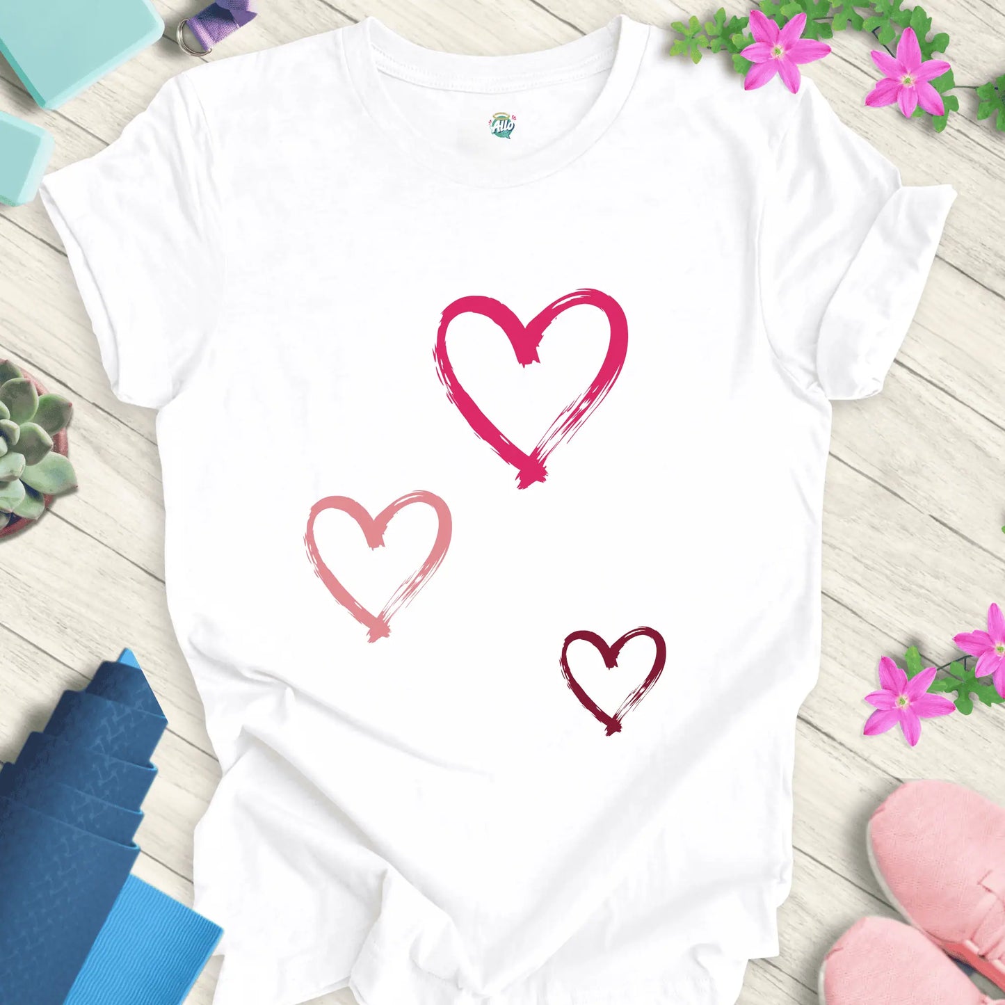White yoga t-shirt with 'Halo Allo Love All Around' design, featuring three heart motifs, perfect for spiritual wellness.