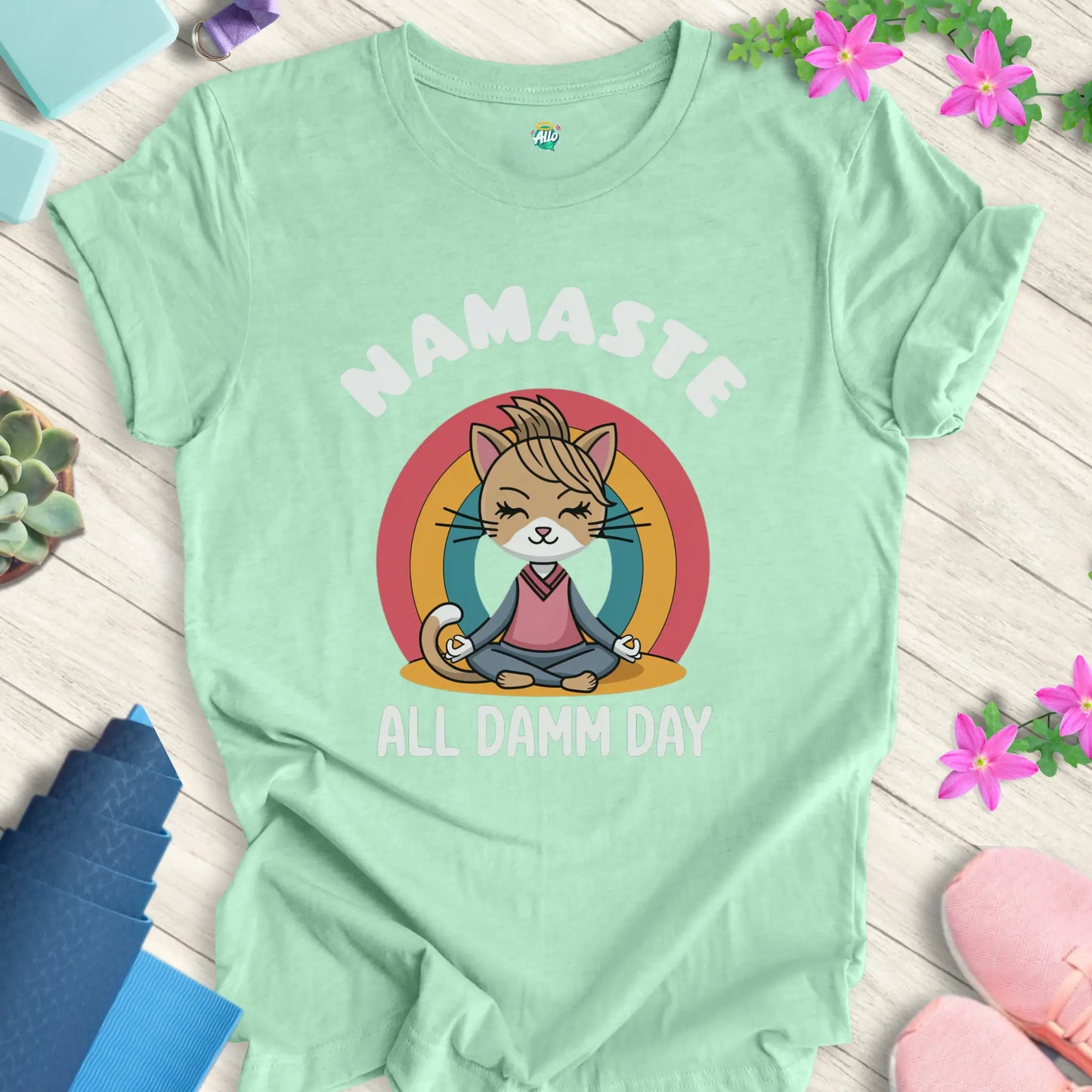 Heather Mint yoga t-shirt with 'Namaste All Damm Day' design featuring a meditative cat by Halo Allo. Perfect for spiritual practice and casual wear.