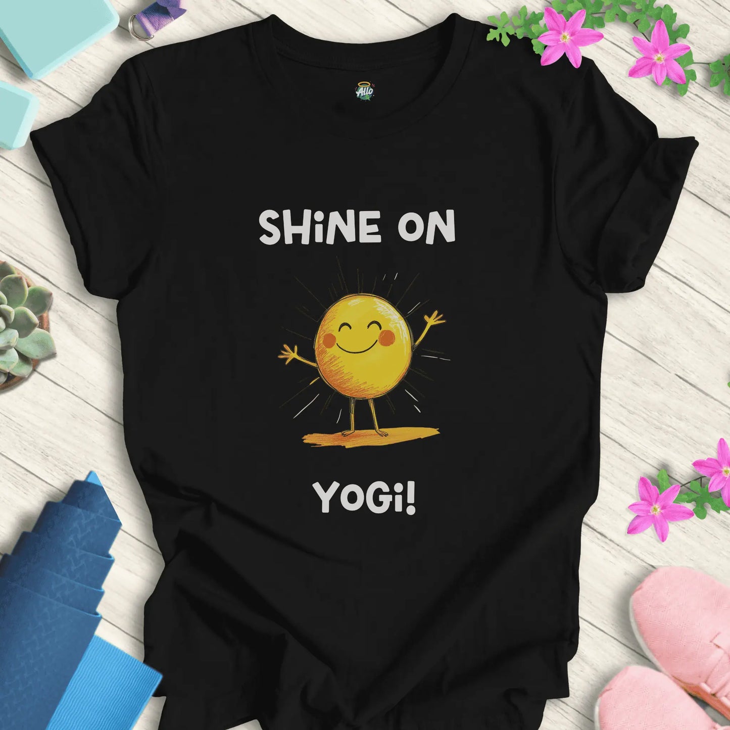Black yoga t-shirt with 'Shine On Yogi!' text and cheerful sun design by Halo Allo, perfect for meditation and spiritual wellness.