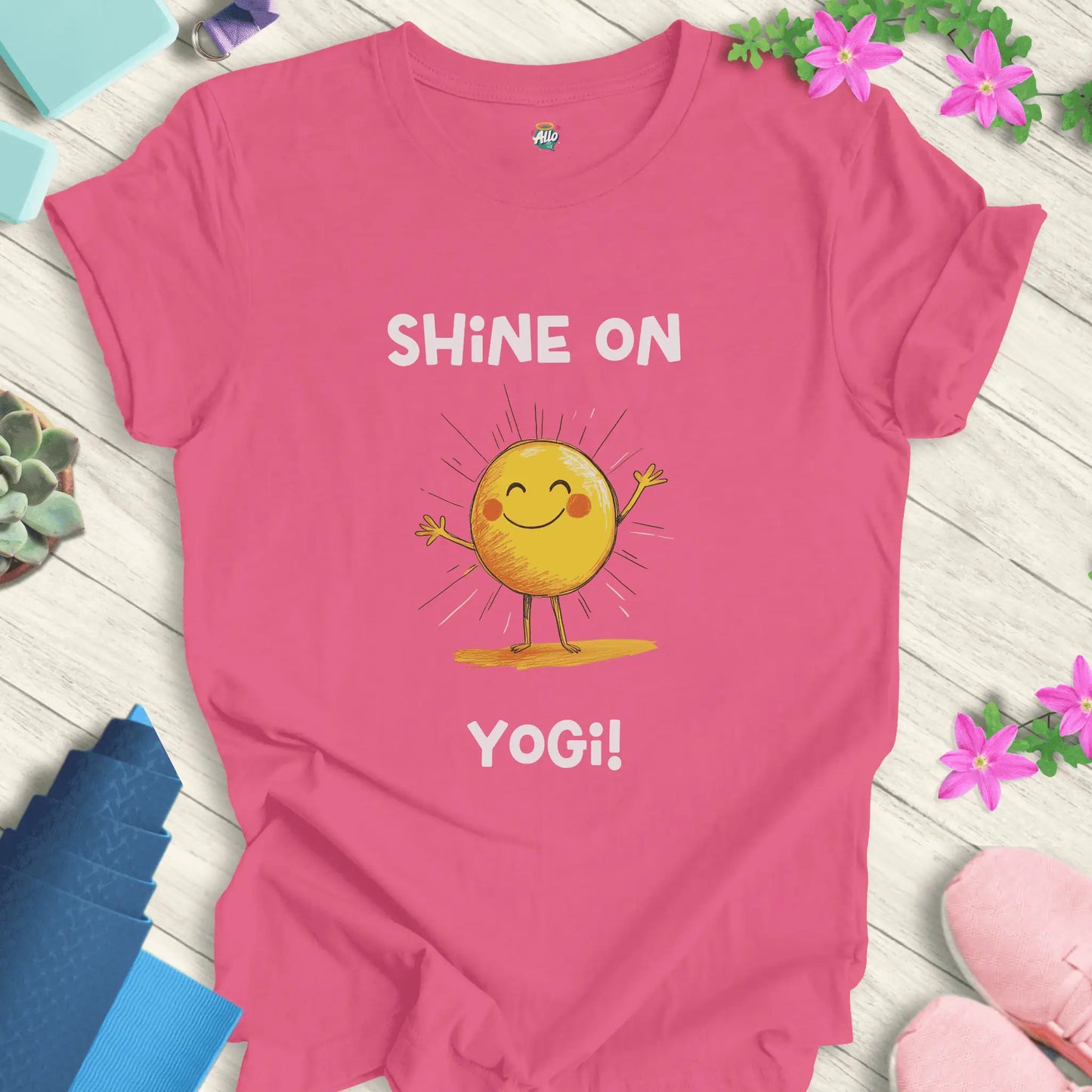 Charity Pink yoga t-shirt with 'Shine On Yogi!' text and cheerful sun design by Halo Allo, perfect for meditation and spiritual wellness.