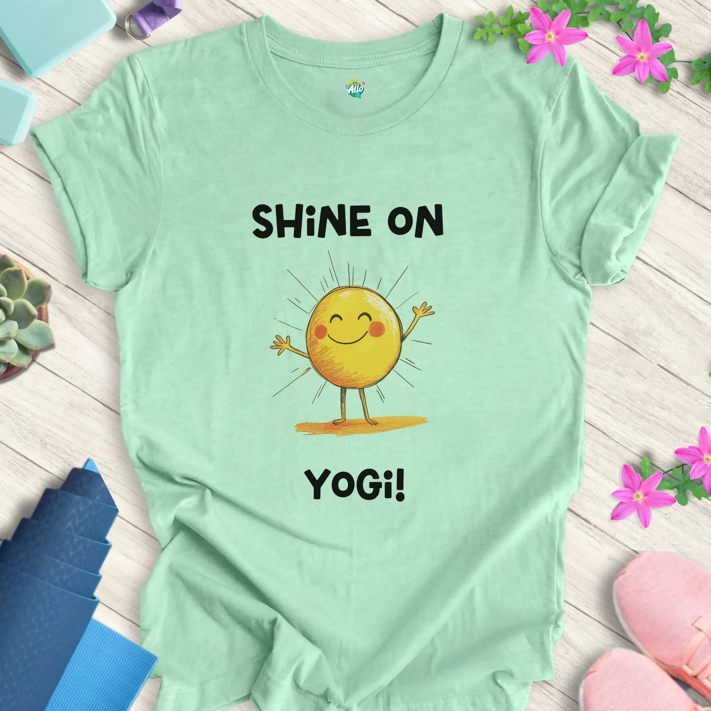 Heather Mint yoga t-shirt with 'Shine On Yogi!' text and cheerful sun design by Halo Allo, perfect for meditation and spiritual wellness.