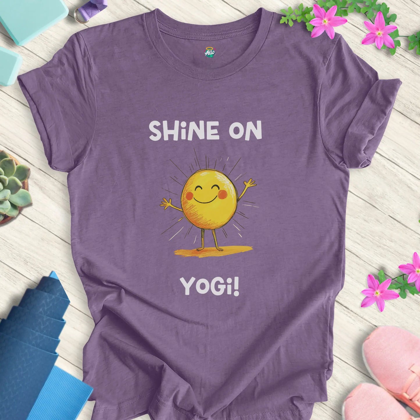 Heather Team Purple yoga t-shirt with 'Shine On Yogi!' text and cheerful sun design by Halo Allo, perfect for meditation and spiritual wellness.