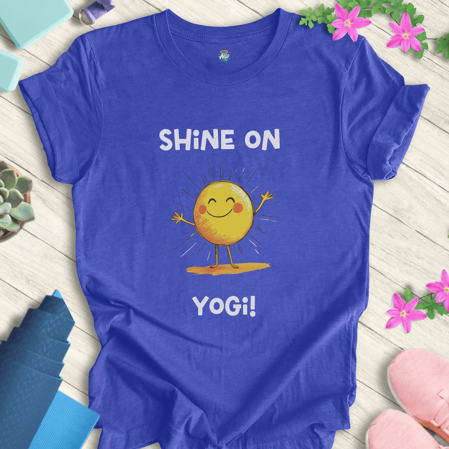 Heather True Royal yoga t-shirt with 'Shine On Yogi!' text and cheerful sun design by Halo Allo, perfect for meditation and spiritual wellness.
