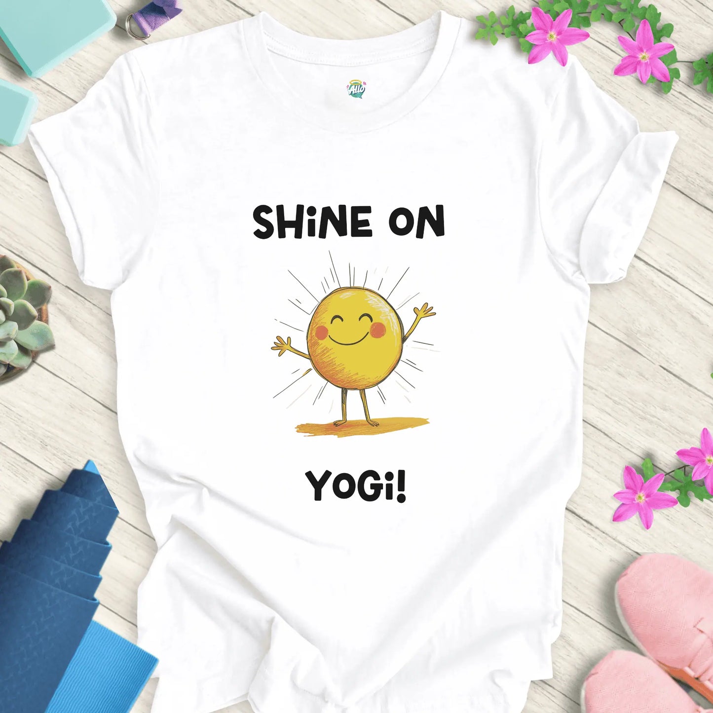 White yoga t-shirt with 'Shine On Yogi!' text and cheerful sun design by Halo Allo, perfect for meditation and spiritual wellness.