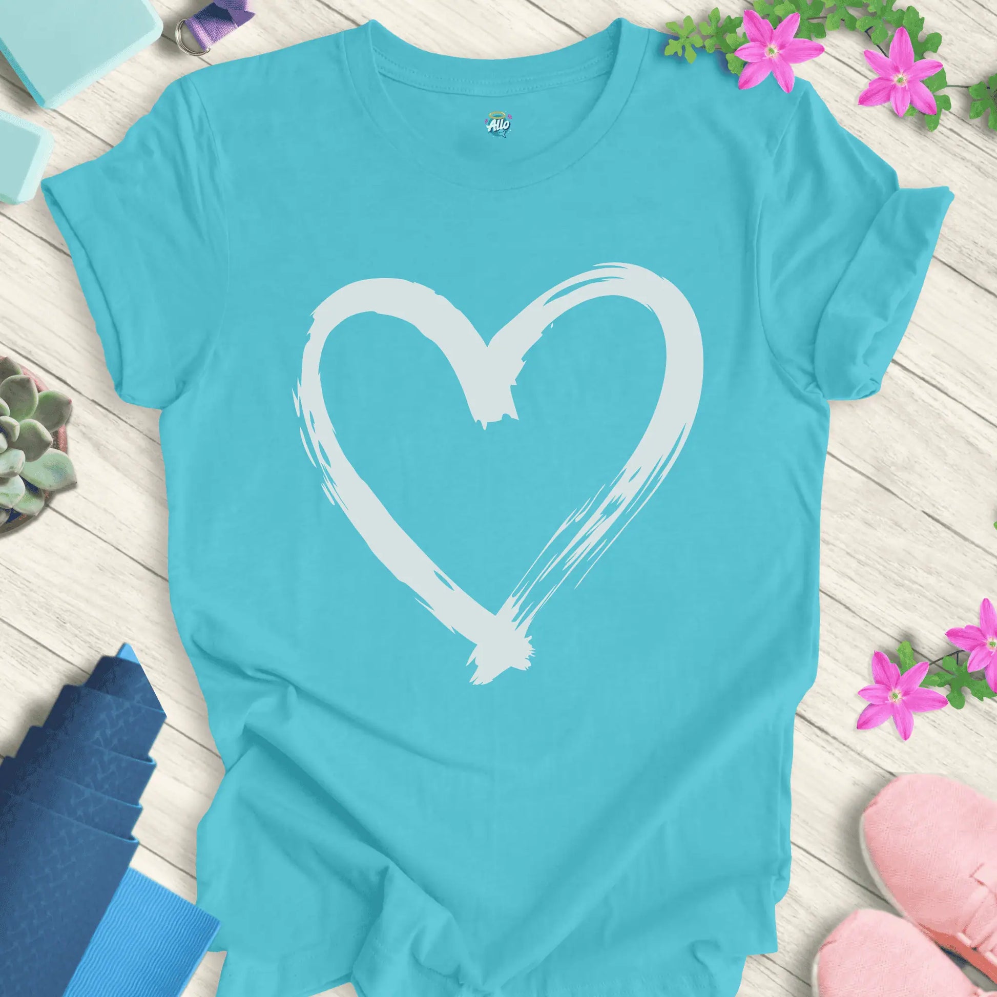 Turquoise yoga t-shirt with Halo Allo's Love design, featuring a white brushstroke heart on soft cotton.