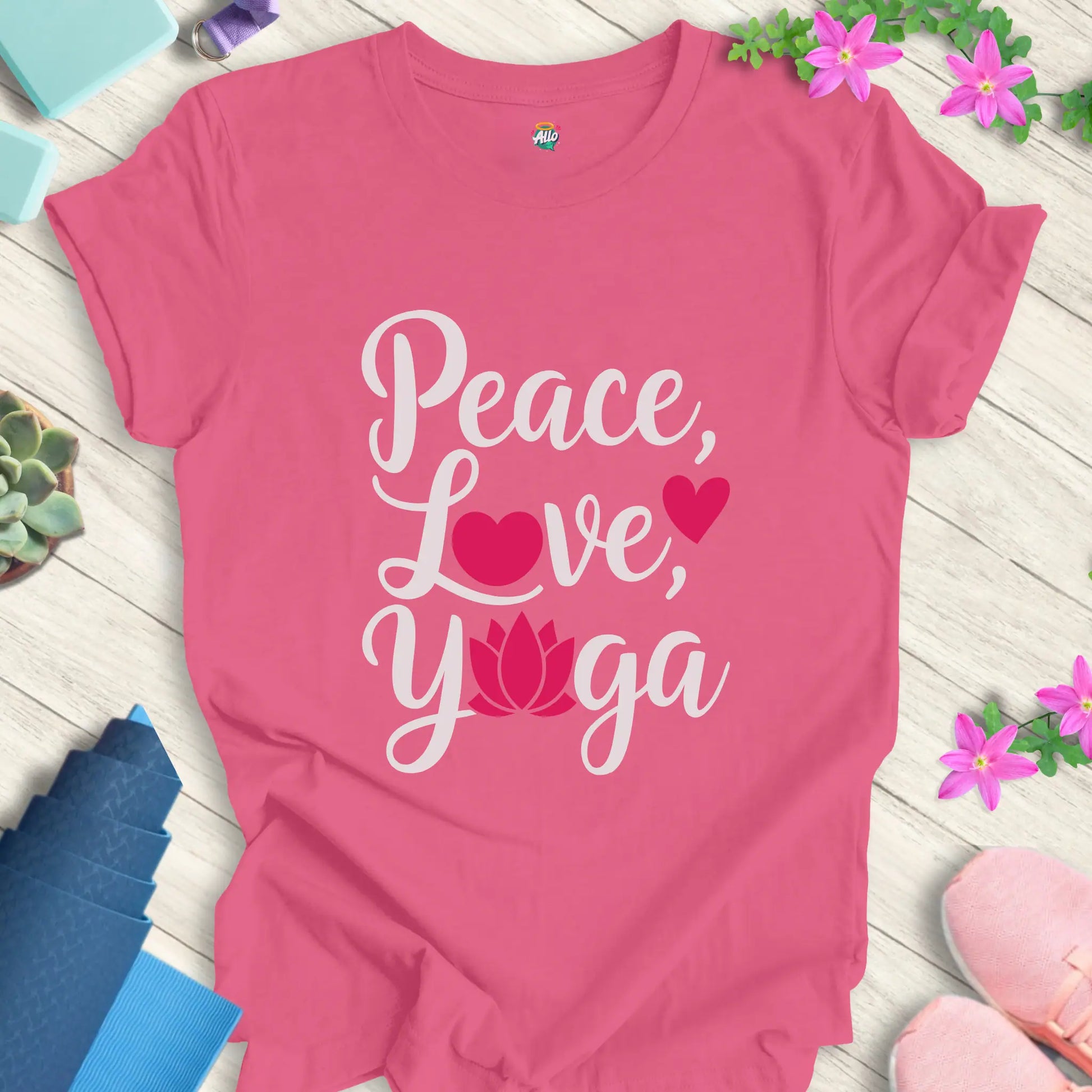 Charity Pink yoga t-shirt with 'Peace, Love, Yoga' design featuring a lotus flower and heart symbols, perfect for meditation and mindfulness.