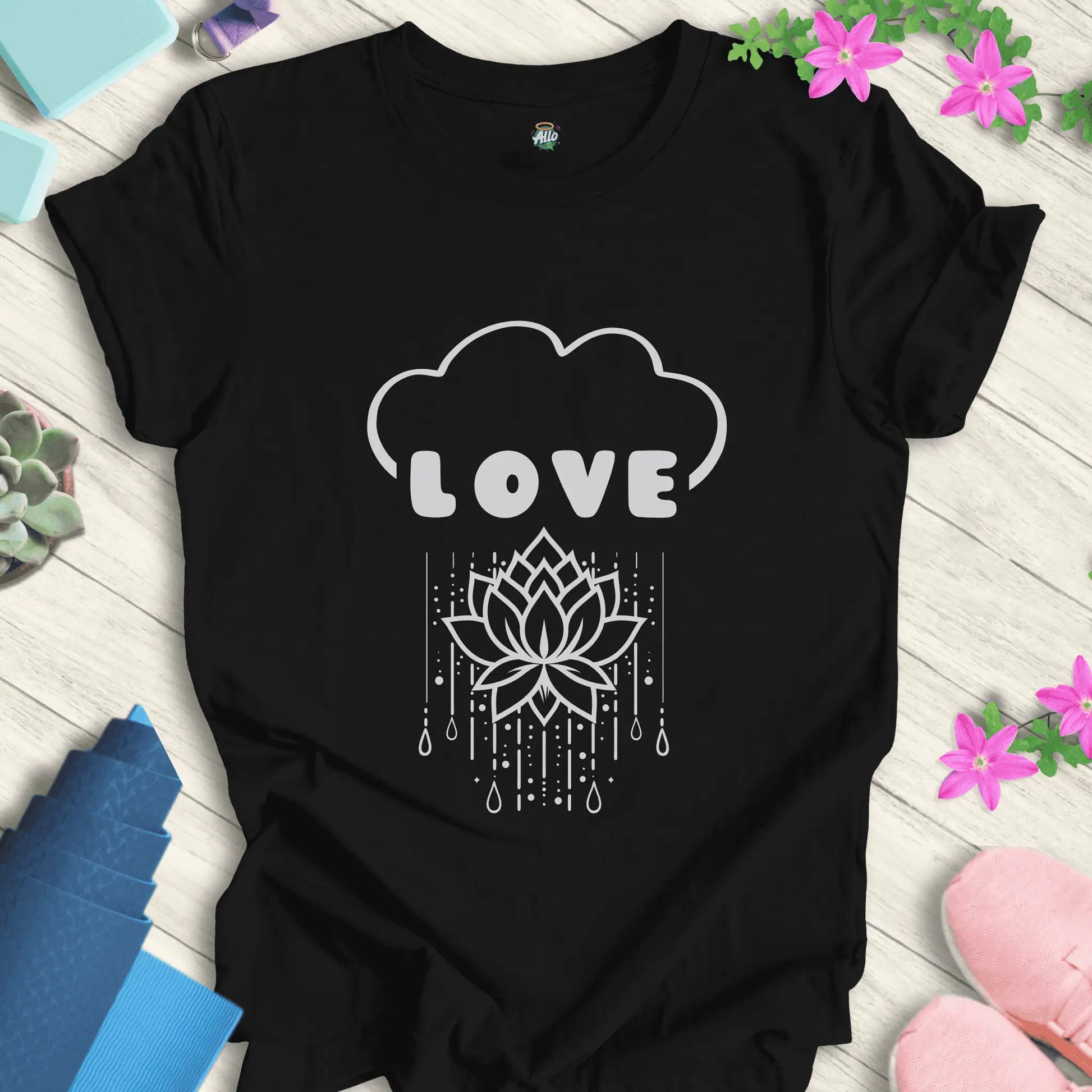 Black yoga t-shirt with 'Rain Down Love' design featuring a lotus flower and cloud motif by Halo Allo.