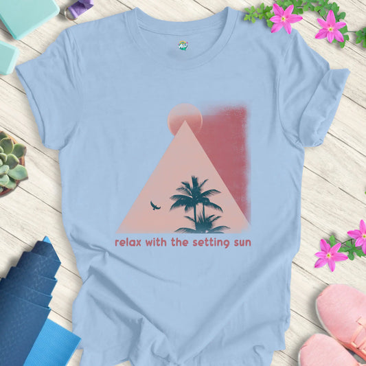 Baby Blue t-shirt featuring 'Relax With The Setting Sun' design with a sunset, palm trees, and bird silhouette.