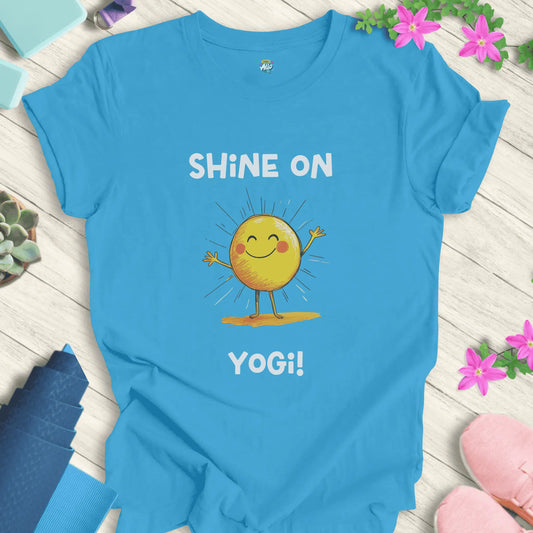 Aqua yoga t-shirt with 'Shine On Yogi!' text and cheerful sun design by Halo Allo, perfect for meditation and spiritual wellness.