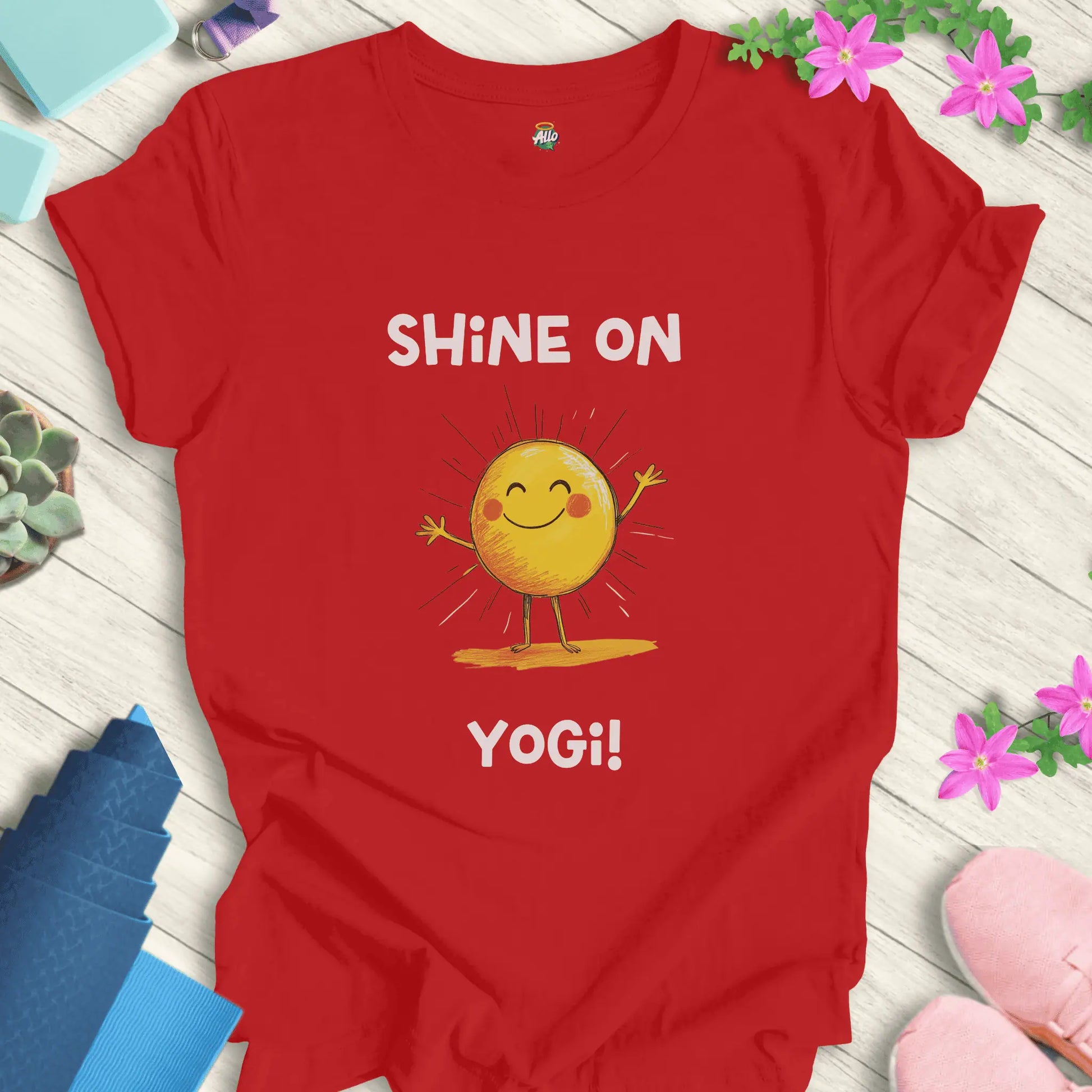 Red yoga t-shirt with 'Shine On Yogi!' text and cheerful sun design by Halo Allo, perfect for meditation and spiritual wellness.