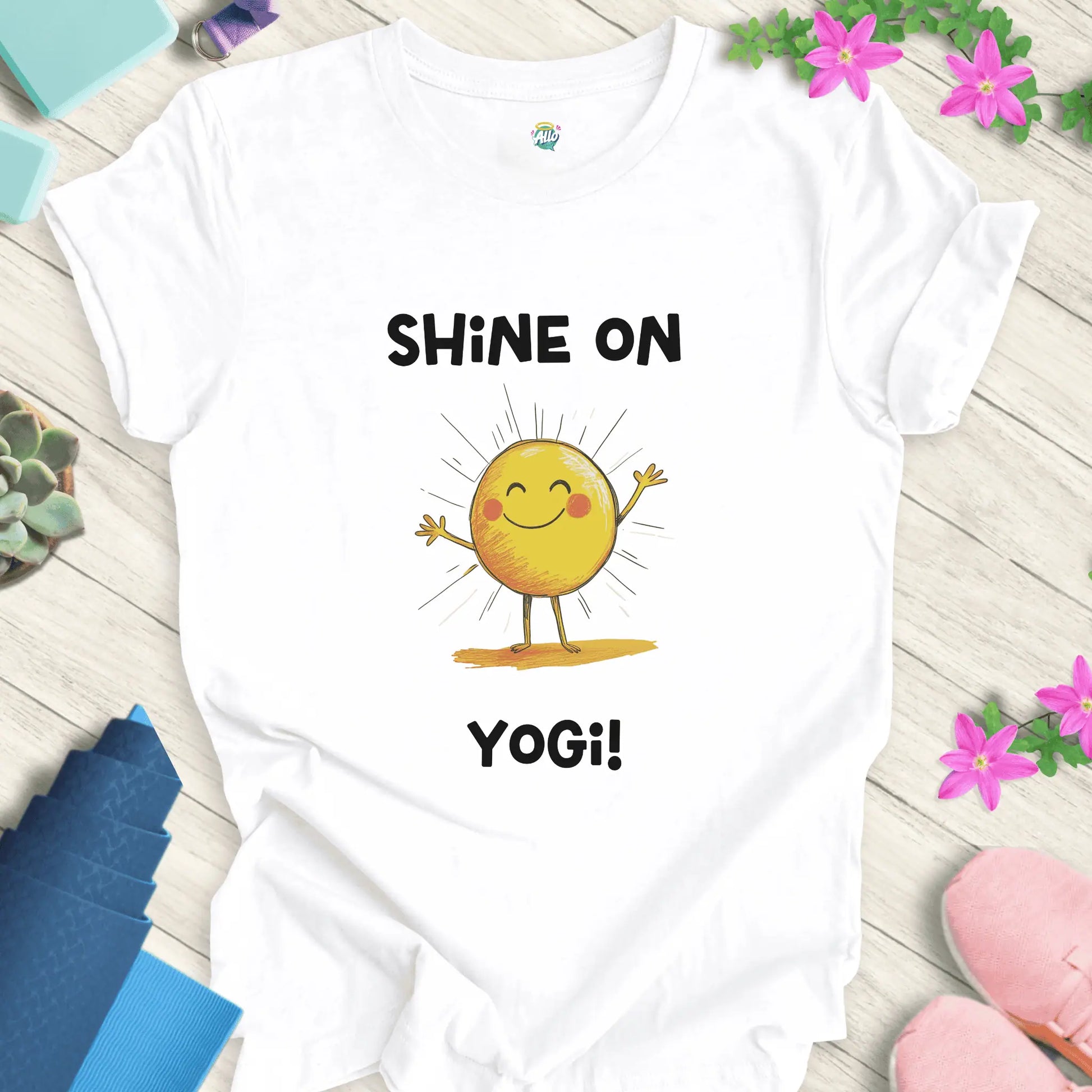 White yoga t-shirt with 'Shine On Yogi!' text and cheerful sun design by Halo Allo, perfect for meditation and spiritual wellness.