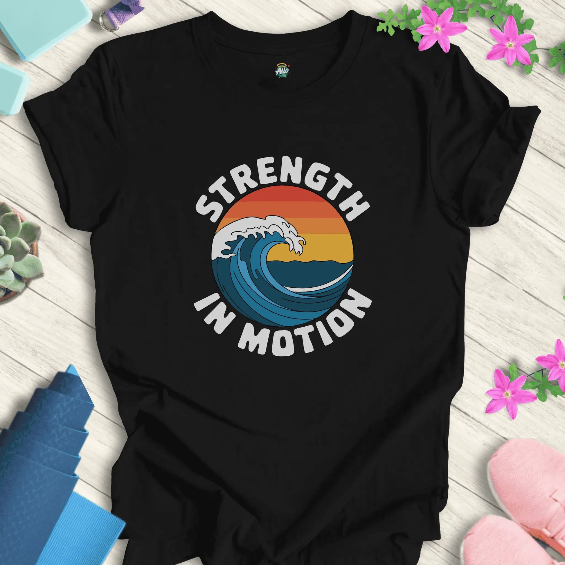 Black yoga t-shirt with 'Strength In Motion' design by Halo Allo, featuring a wave graphic. Perfect for meditation and mindfulness.