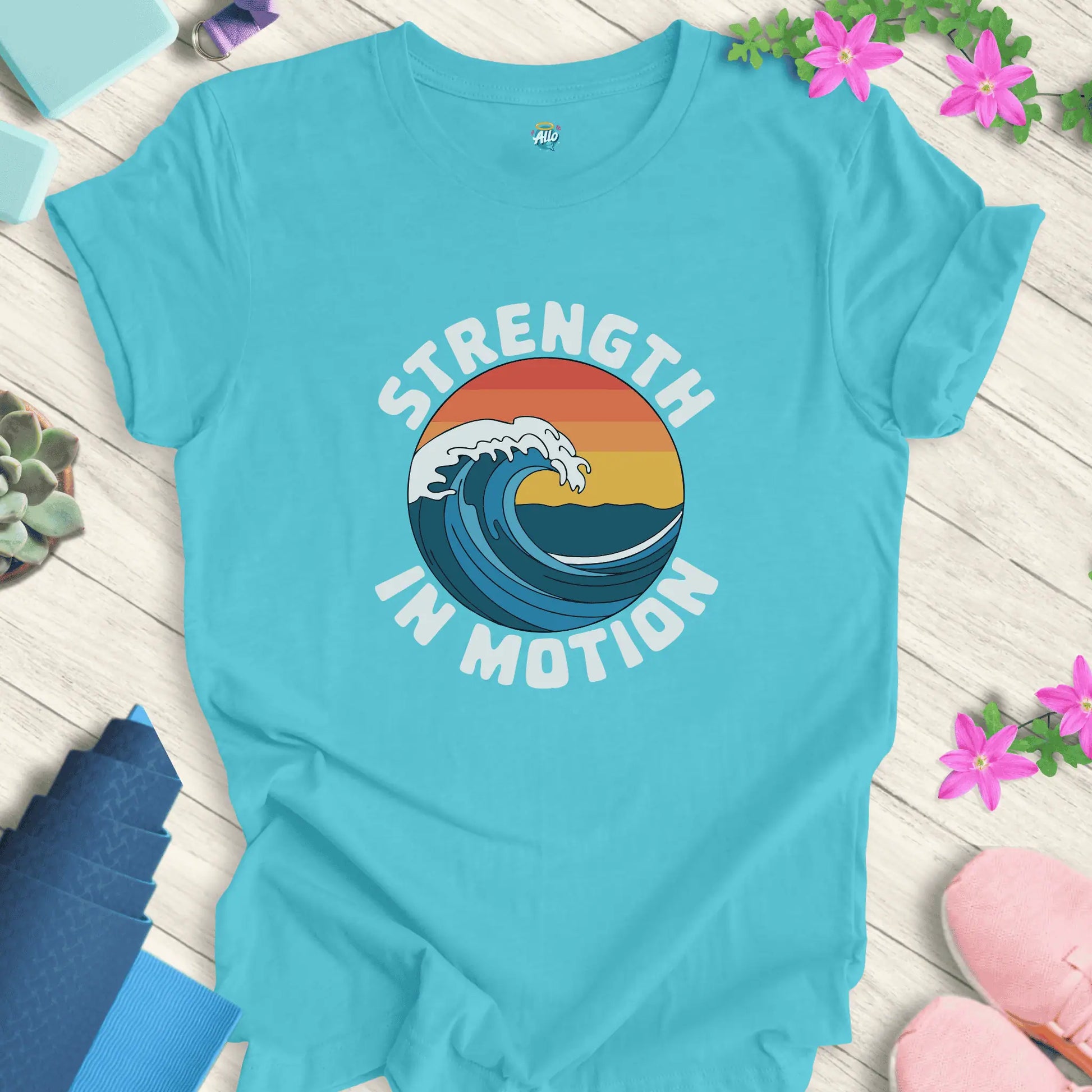 Turquoise yoga t-shirt with 'Strength In Motion' design by Halo Allo, featuring a wave graphic. Perfect for meditation and mindfulness.