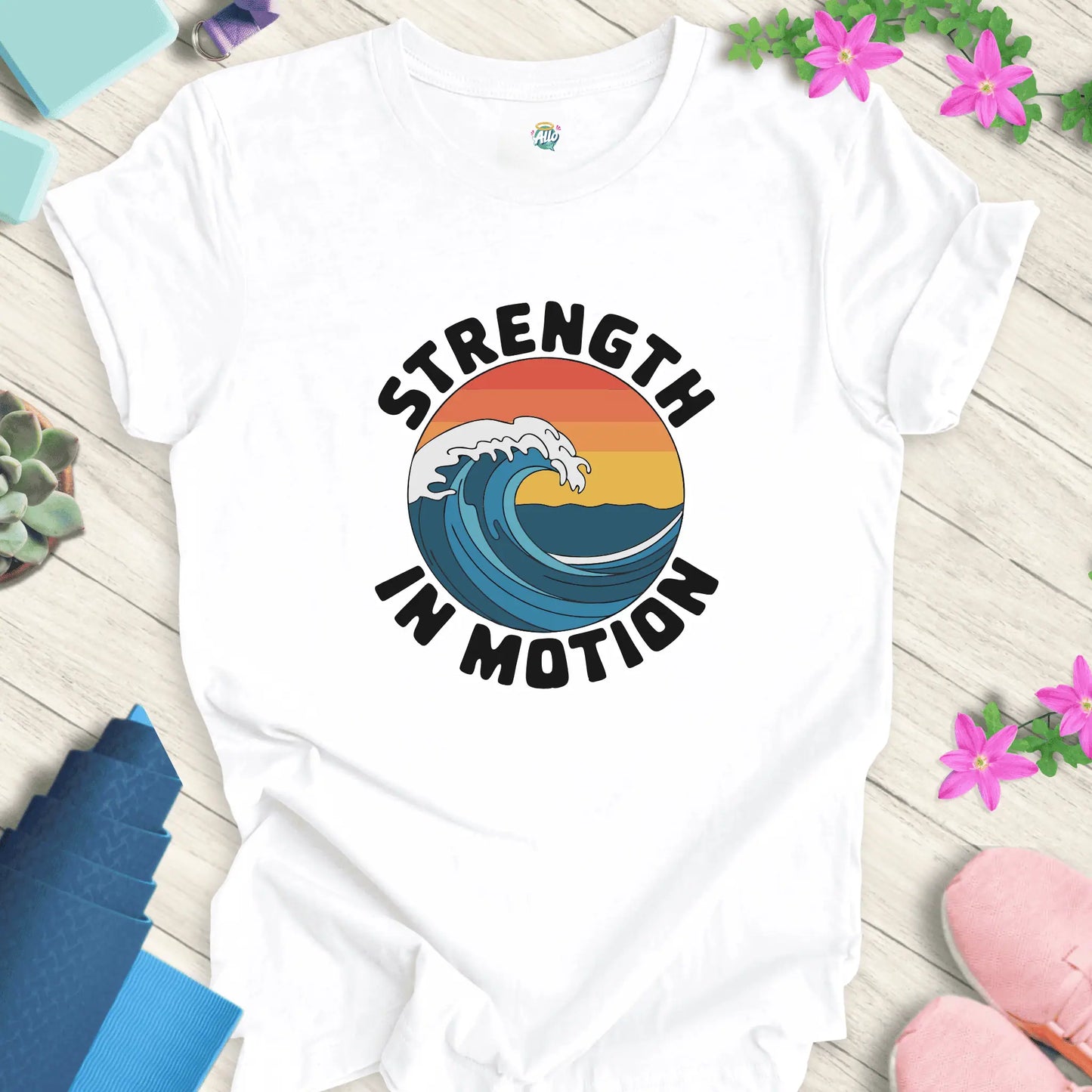 White yoga t-shirt with 'Strength In Motion' design by Halo Allo, featuring a wave graphic. Perfect for meditation and mindfulness.