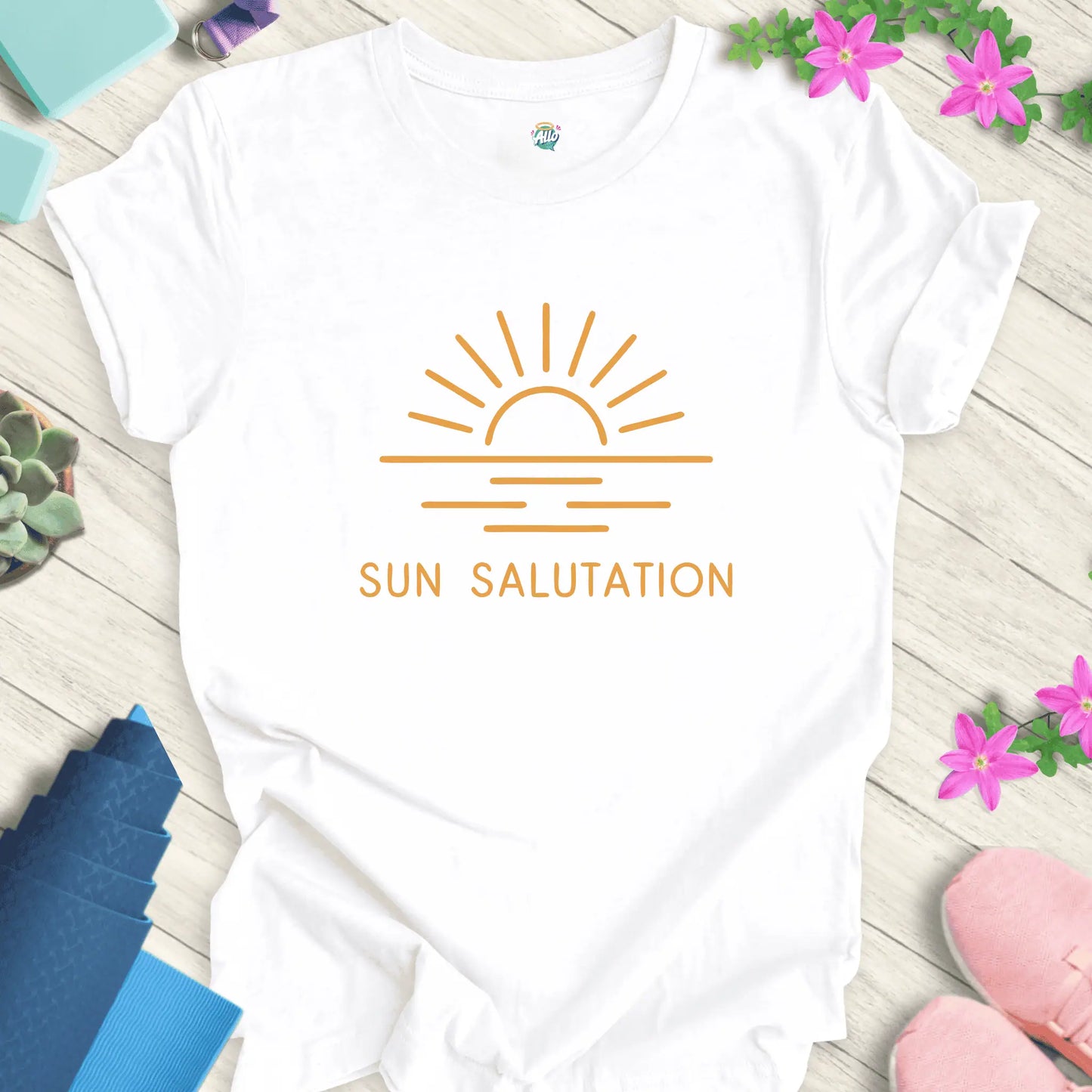White yoga t-shirt with 'Sun Salutation' design by Halo Allo, featuring a sunrise motif. Perfect for meditation enthusiasts.